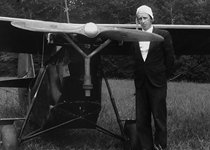 Chris Stoltzfus standing with crop duster