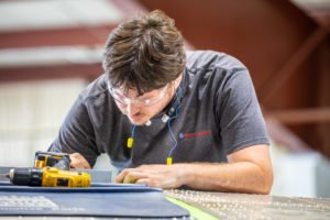 Dynamic Aviation employee performing sheet metal work