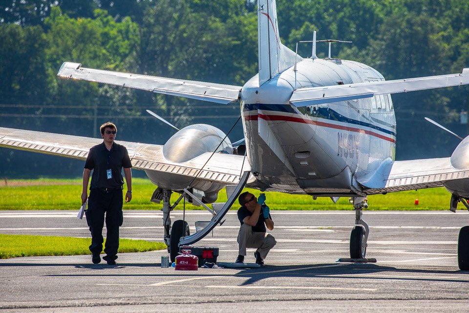 Dynamic Aviation employee inspecting King Air 90