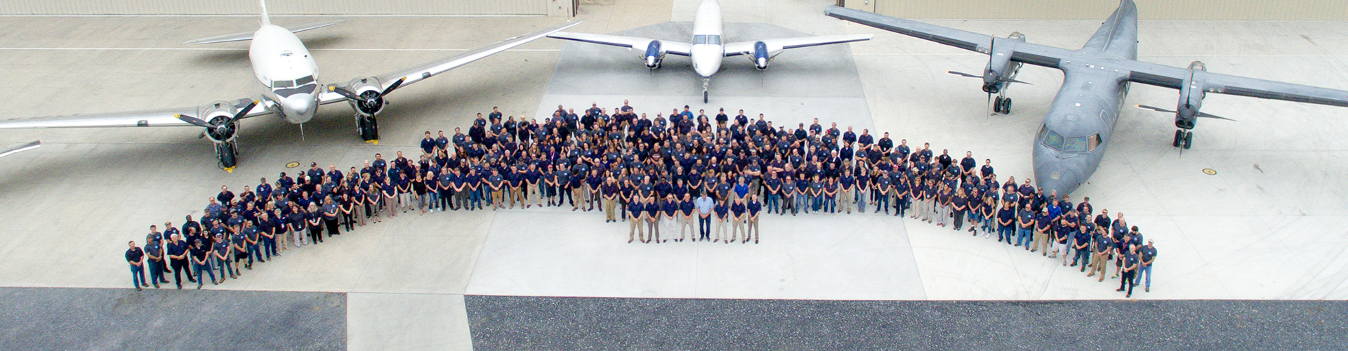 Dynamic Aviation employees outside of hangars