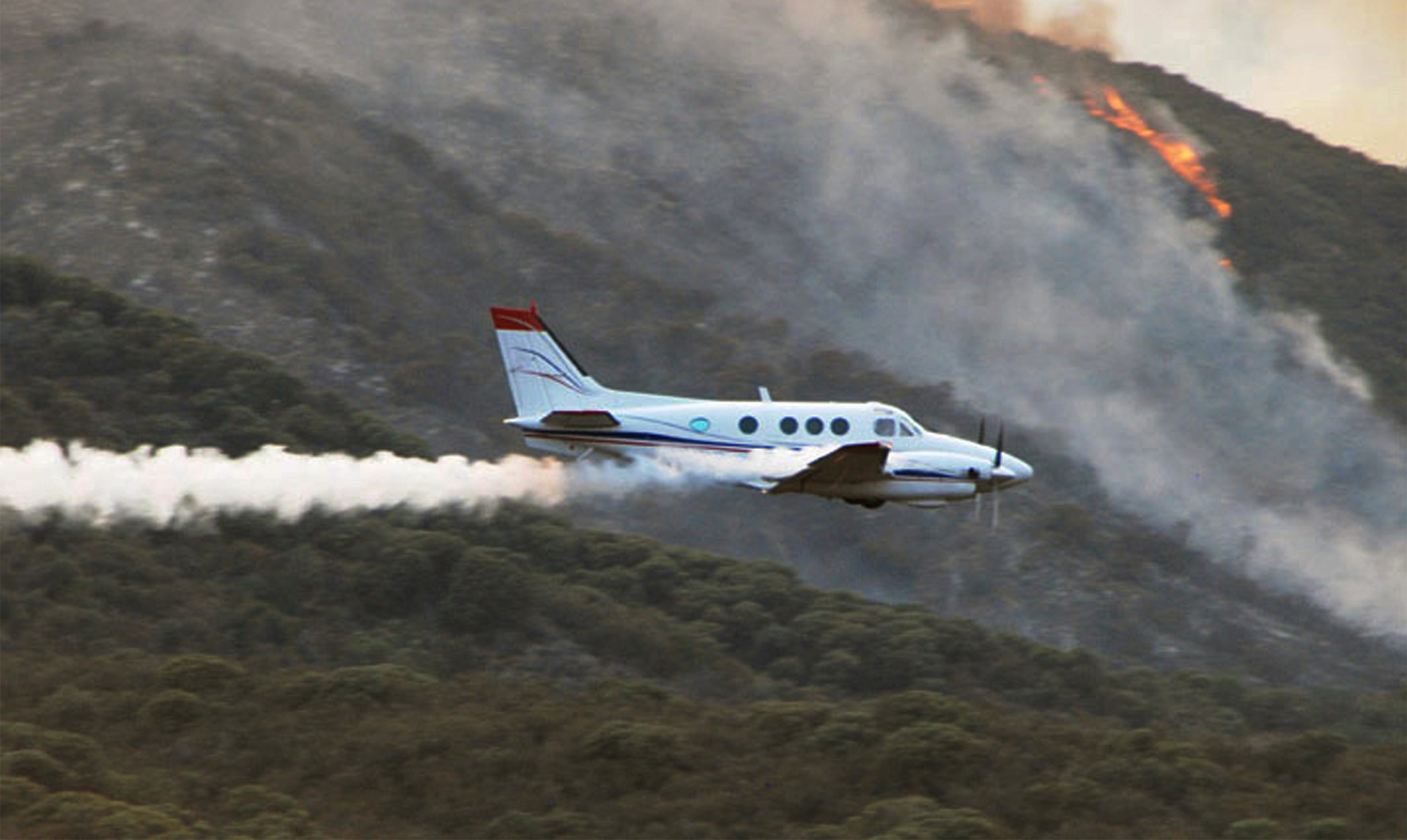 King Air 90 releasing smoke to indicate where tanker should drop deterrent