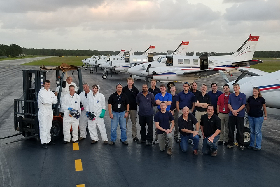 Employees posing for photo while on mosquito control project