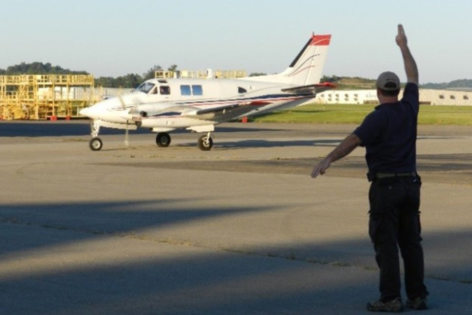 King Air 90 being signaled onto runway