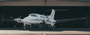 King Air 200 in front of hangar door